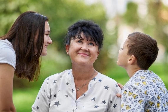 woman in white and black floral button up shirt smiling